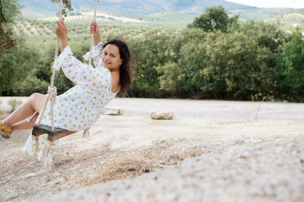 istock Woman enjoying time on a swing in nature 2158017237