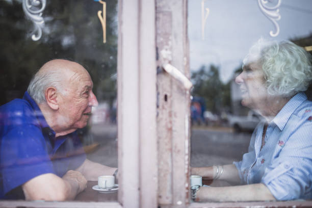 istock Senior Couple Enjoying Coffee at a Cafe Window 2158019641