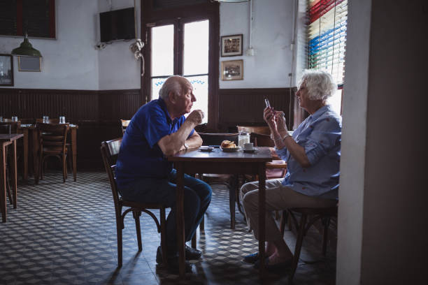 istock Senior Couple Enjoying Coffee in Cozy Cafe 2158019647