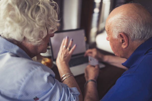 istock Senior Couple Reading Documents on Laptop 2158019693
