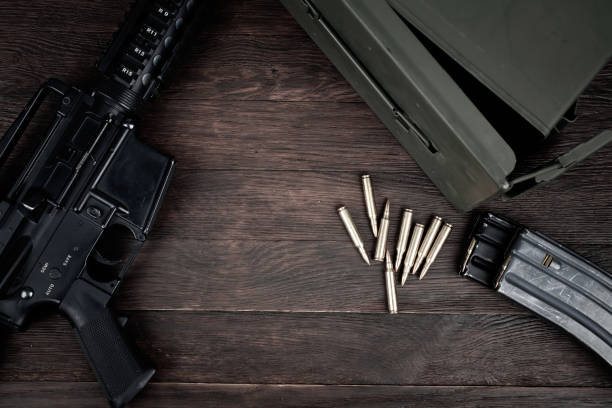 istock Rifle and Ammunition with magazine on wooden table 2158022124