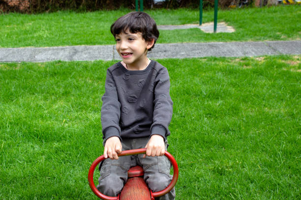An Active little boy having fun on playground