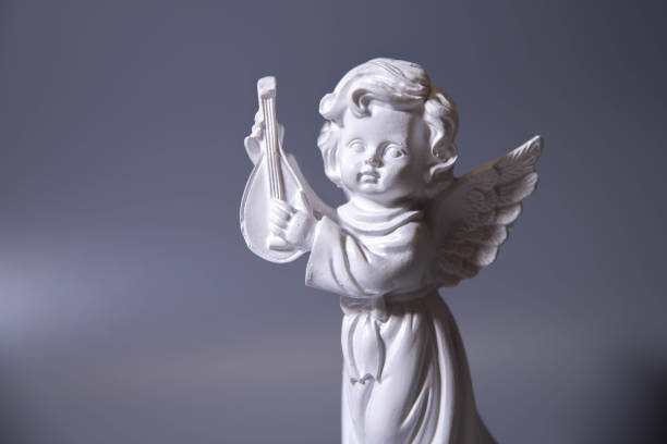 istock Angel figure with musical instrument on cloud 2158026418