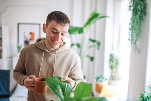 istock Morning Serenity: A Young Man’s Tranquil Moment with Nature and Coffee at Home 2158026927