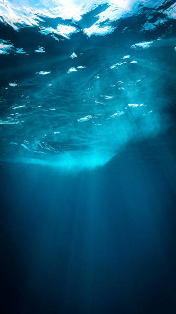 istock Rays of sunlight in the deep blue sea 2158033904