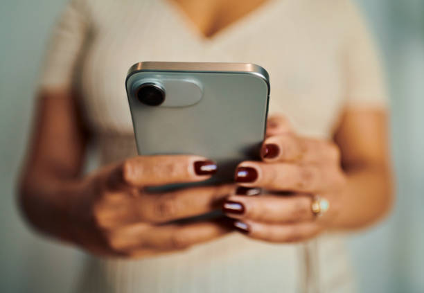 istock Digital Connection: Close-Up of Woman's Hands Texting on Mobile Phone 2158034391