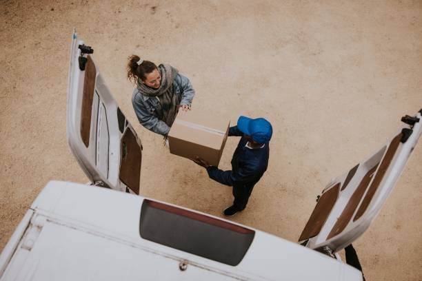 istock Delivery man handing box to customer 2158036718