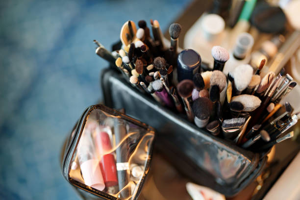 Set Of Brushes And Cosmetics On Wooden Table
