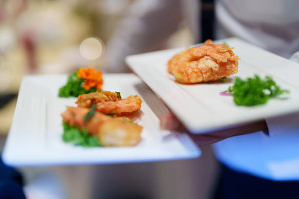 A close-up shot captures a waitress walking in a restaurant while carrying dishes.