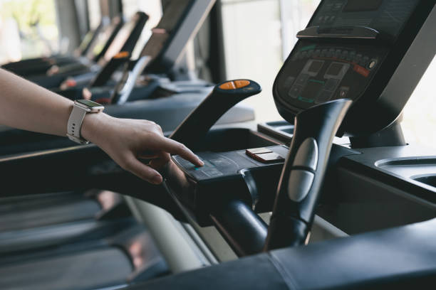 istock A woman is touching a machine with a button on it 2158037732