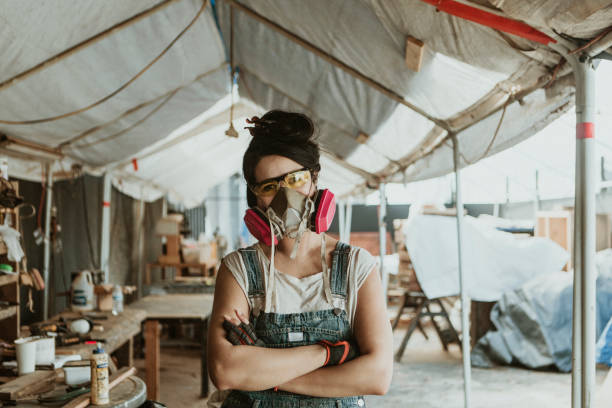 istock Female carpenter with personal protective equipment 2158037889