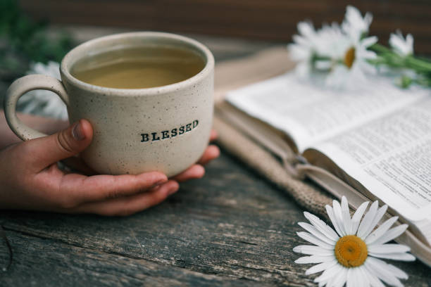 istock Cup with the inscription blessed and open Bible, Christian concept 2158039511