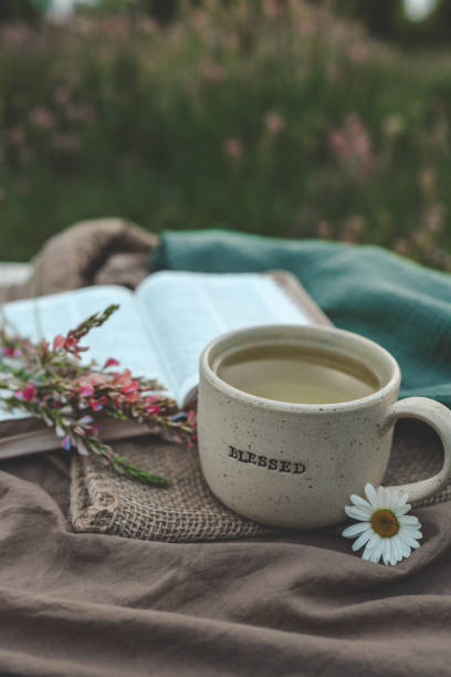 istock Cup with text BLESSED and open Bible in the garden, good morning 2158039517