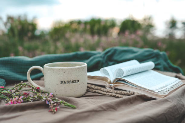 istock Cup with text BLESSED and open Bible in the garden, good morning 2158039524