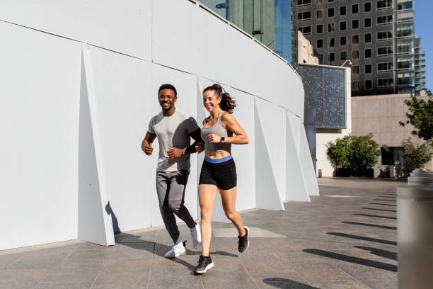 istock Man and woman running together 2158040473