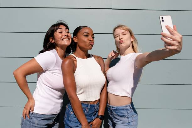 istock Beautiful diverse women taking a selfie, wearing plain white clothes 2158040775