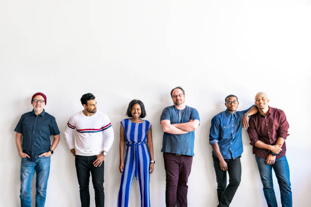 istock Group of people standing in a by a white wall 2158043003