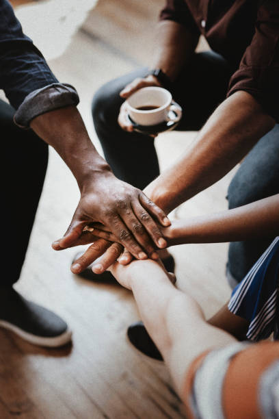 istock Diverse people joining hands in the middle 2158043590