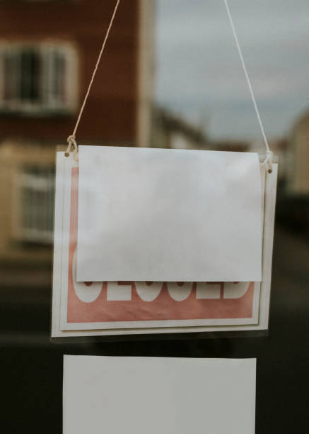 istock Blank paper sign hanging on a closed shop window 2158043955
