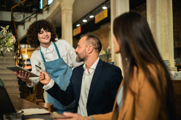 istock Two business people ordering a meal while working together at the restaurant 2158044197