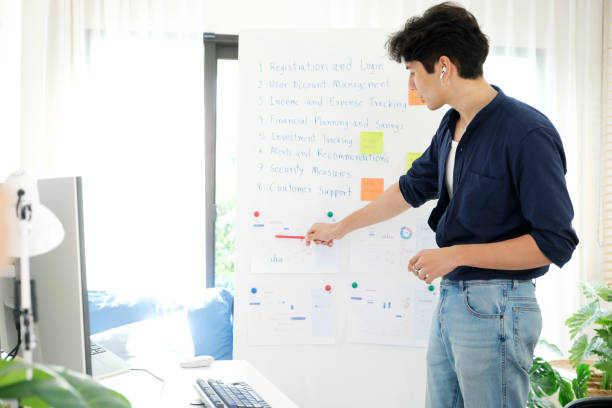istock Young man present business finance data by online meeting with computer at home office, Work from home, Teleconference 2158044415