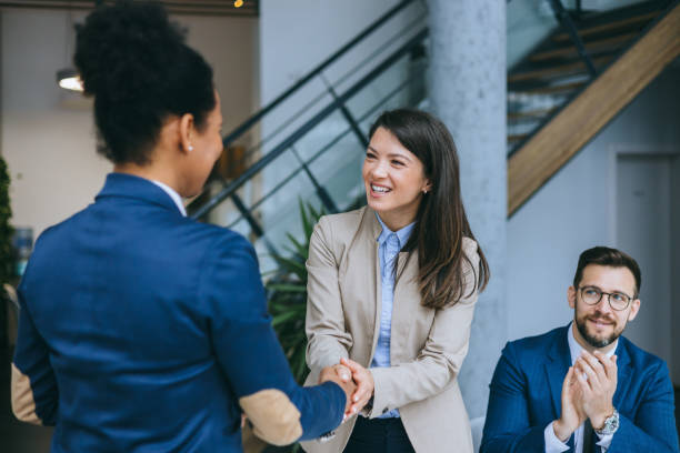 istock Two colleagues greeting with handshake in office 2158044586