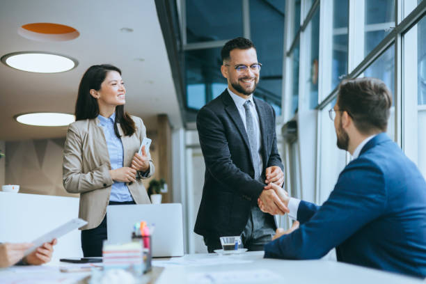 istock Two business professionals handshake in office meeting 2158044610