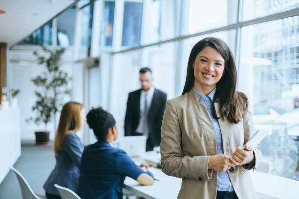 istock Confident businesswoman with colleagues 2158044613