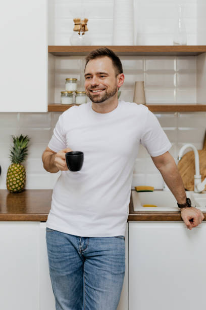 istock Happy man drinking coffee in the kitchen 2158045017