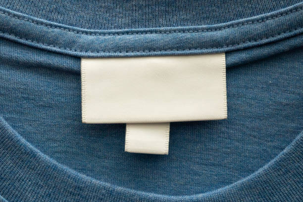 istock Blank white laundry care clothes label on blue shirt fabric texture background 2158045191