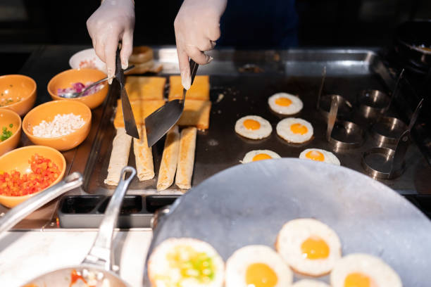 istock The hotel chef stirs the rolls in a pan and spatula until they are crispy and crispy. For guests waiting to eat Contains condiments such as tomatoes, onions, cilantro, and spring onions. 2158045354