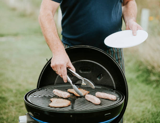 istock Man grilling meat sausages outdoor 2158045401