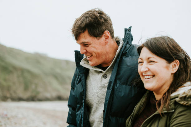 istock Cheerful couple enjoying at the beach 2158045720
