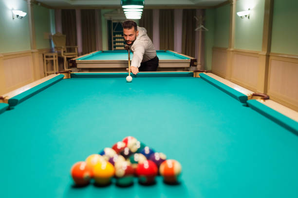 istock Billiard player at billard table or snooker american billiards pool sport game 2158046646