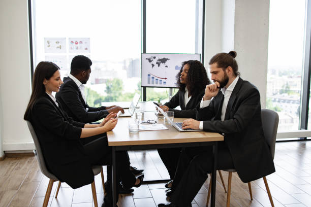 istock Business meeting with diverse team discussing data reports 2158049640