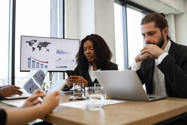 istock Business colleagues in a meeting analyzing data on screens and documents 2158049662