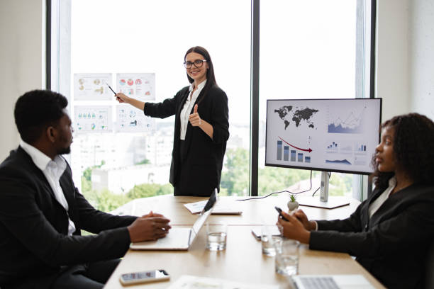 istock Business woman presenting to colleagues in modern office setting 2158049722