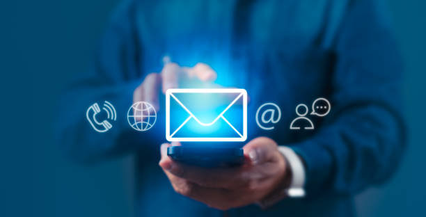 istock A man is holding a cell phone with a communication icons on the screen 2158050018