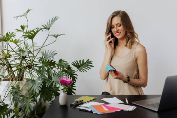 istock Female fashion designer talking on a phone with her client 2158050132