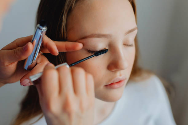 istock Beauty blogger applying mascara to her model 2158050185