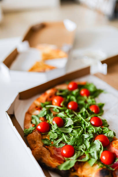 istock Slices of rocket and tomato pizza 2158050279