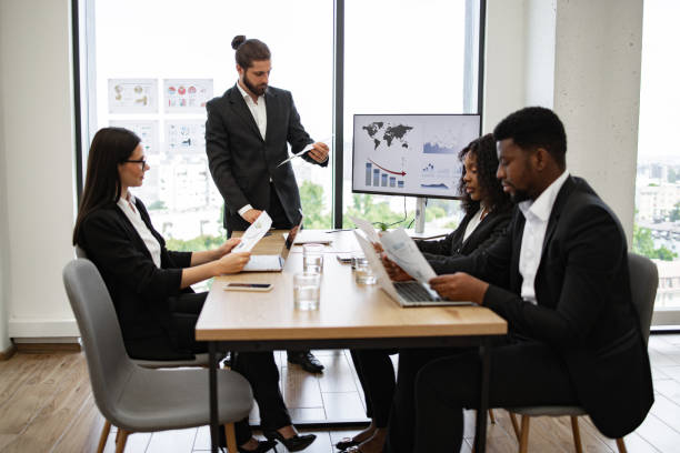 istock Business meeting with team discussing financial reports and charts 2158051296