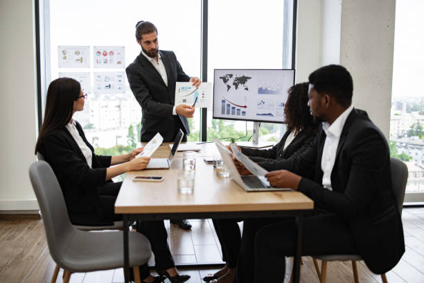 istock Business team in formal meeting discussing charts and graphs 2158051302