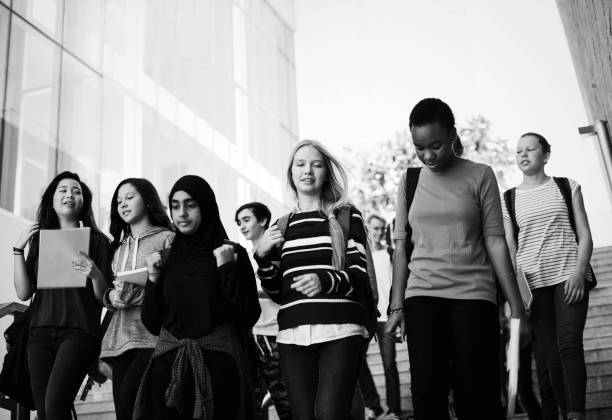 istock Diverse group of students walking in school 2158051529