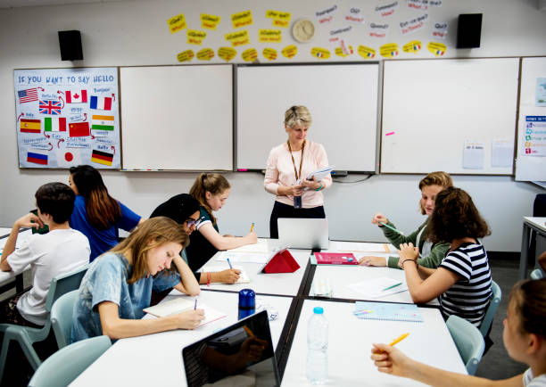istock Group of diverse high school students studying in class 2158051565