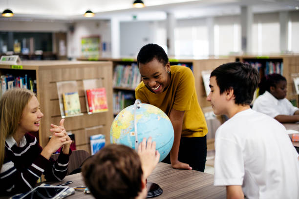 istock Group of diverse high school students with globe ball 2158051664