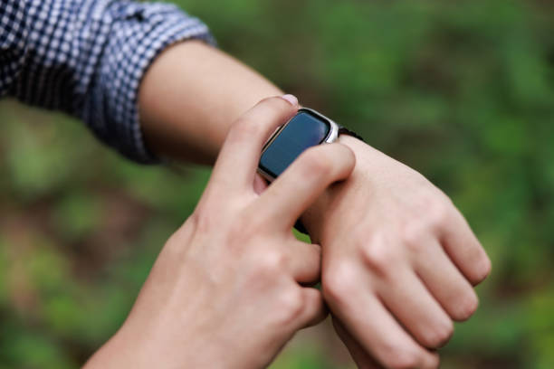 istock Close up, man using smart watch, setting up his smart watch in the forest, goal achievement, sport and fitness concept outdoors in nature. 2158054191