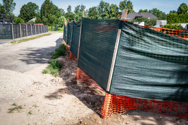 istock Fence around the construction site with cover against construction dust 2158054393