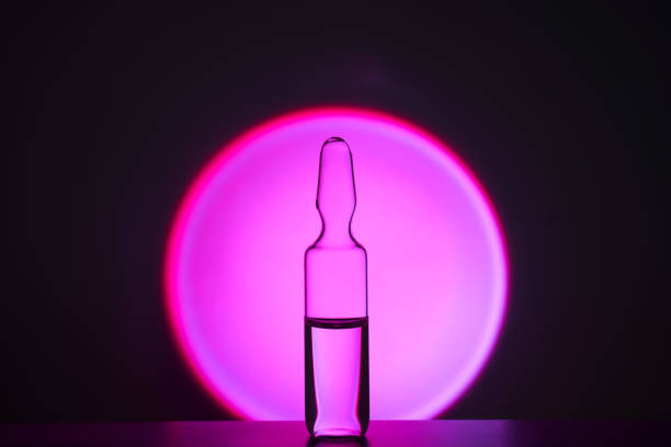 istock Several ampoules for injection with medicines on a lilac background. 2158054764