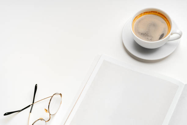 istock Blank paper, coffee cup and glasses on white desk 2158054806